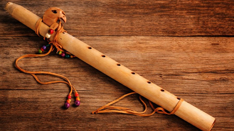 Bamboo Cherokee flute being played, showing hand and finger position