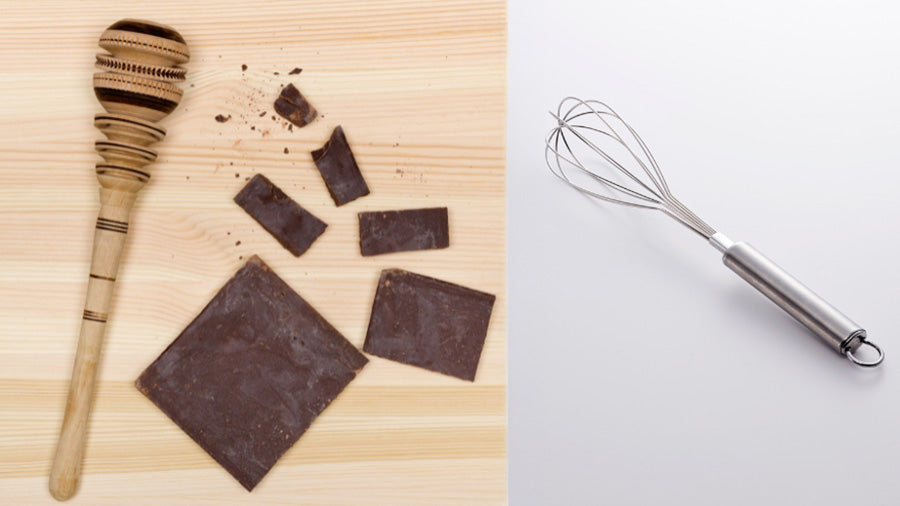 Mexican Molinillo whisk with chocolate on the left and balloon whisk on the right for comparison.