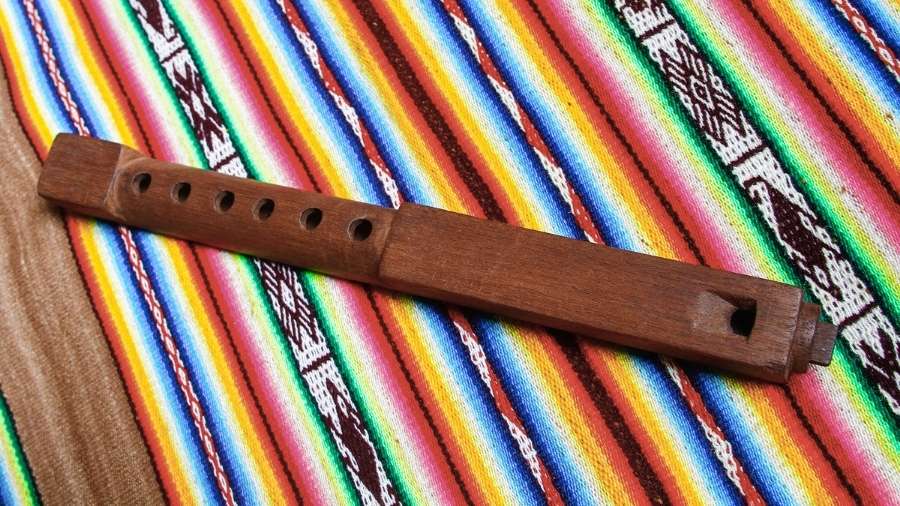 Solid wood peruvian tarka flute on lana wool rug