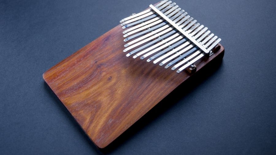 Traditional wooden kalimba isolated on a black background.