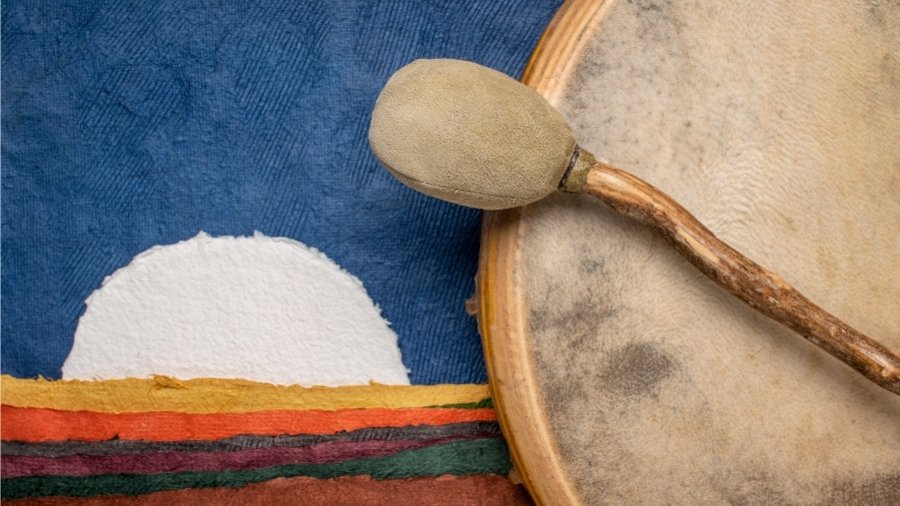 Close up of a shamanic drum beater on a colorful background