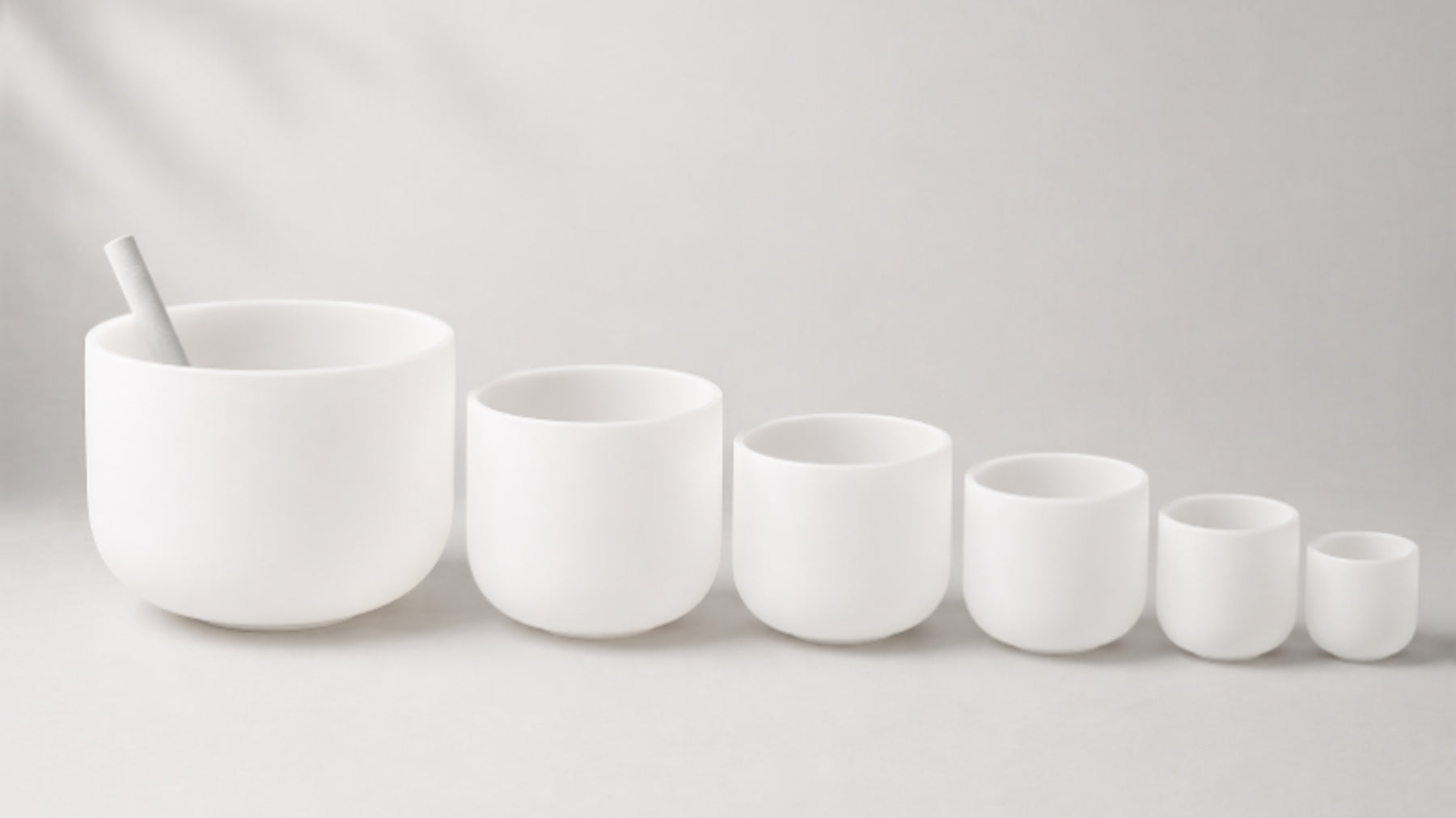 Crystal singing bowls of different sizes and a mallet