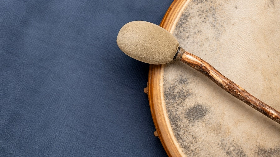 Close up of a shamanic drum beater on a colorful background