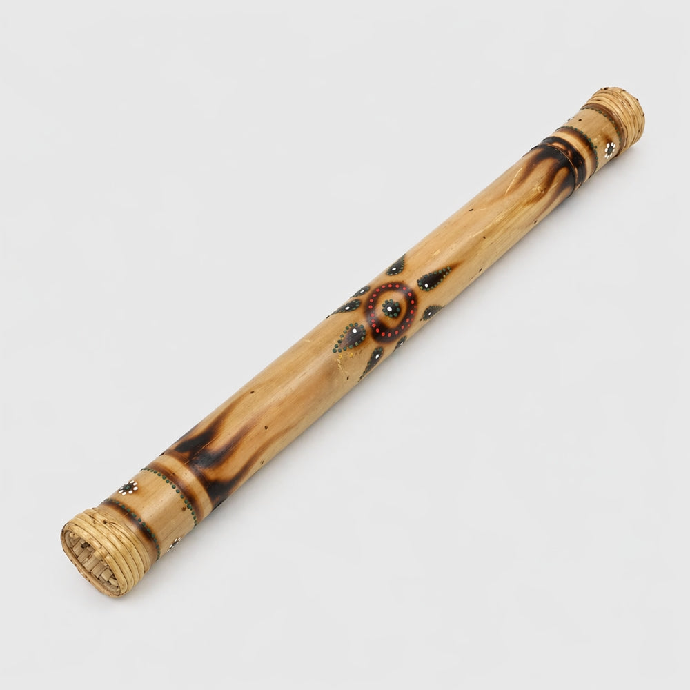60cm bamboo rainstick with decorative patterns on a light gray studio background