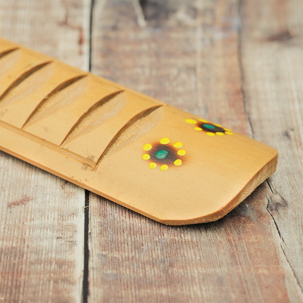 Close-up of the hand-painted design on the Bamboo Rumbai guiro, highlighting its intricate artwork and texture.