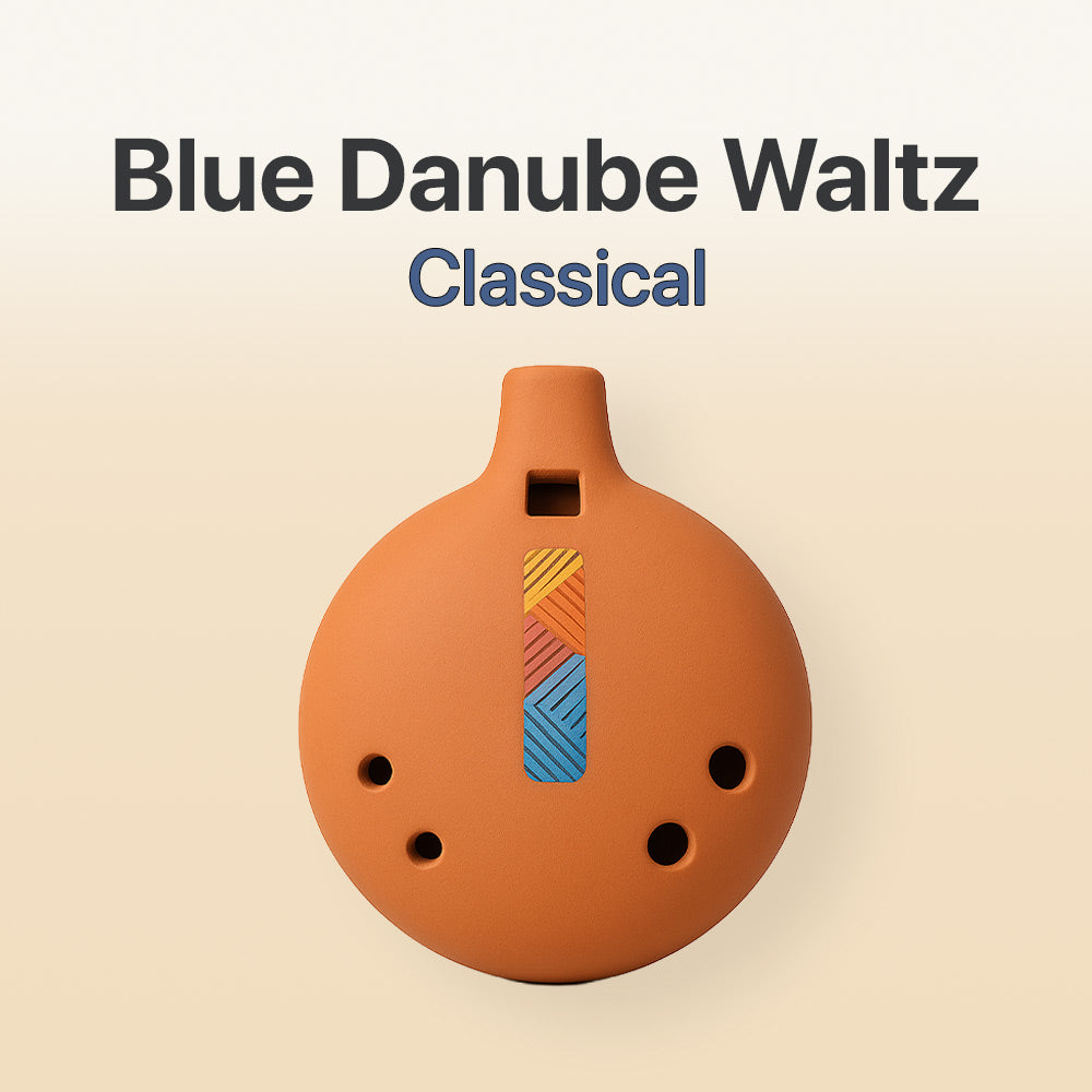 Ceramic ocarina with geometric design on a beige background, labeled 'Blue Danube Waltz Classical'.
