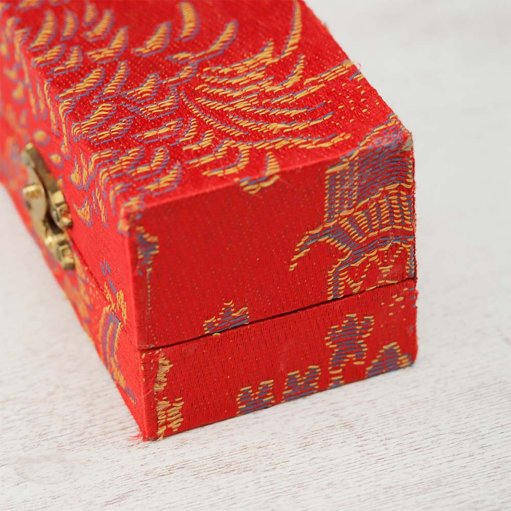 Close-up of the red boading box, featuring an intricate Asian style design on the exterior.