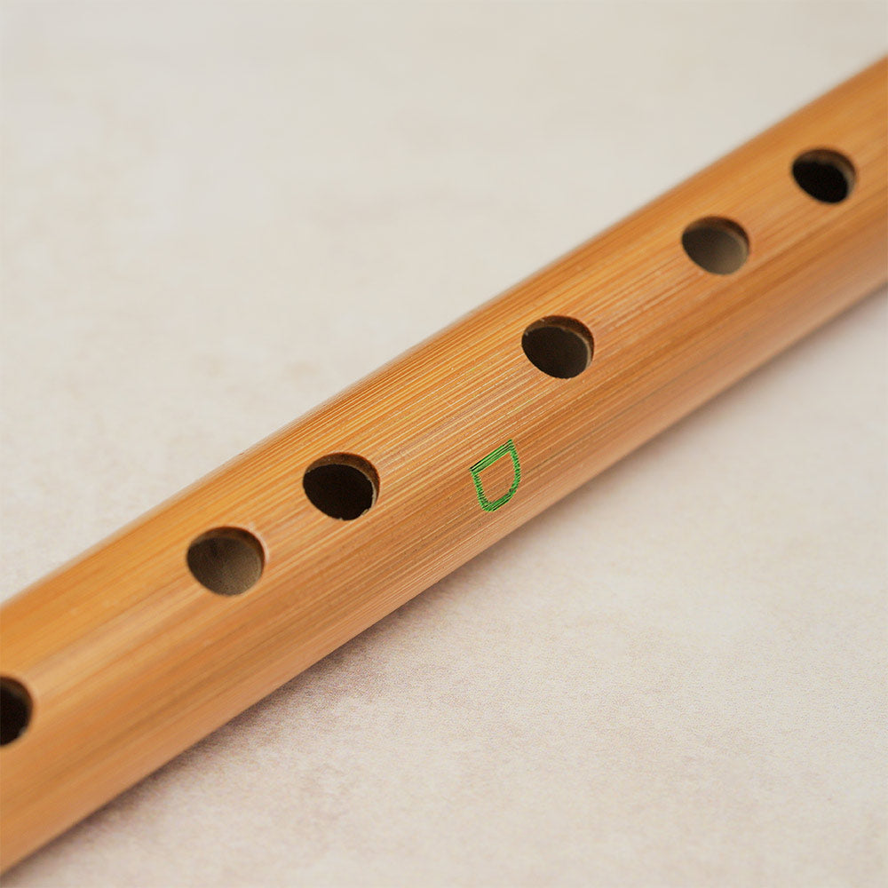 Close-up of the fingering note hole on a Chinese bamboo flute tuned to D.