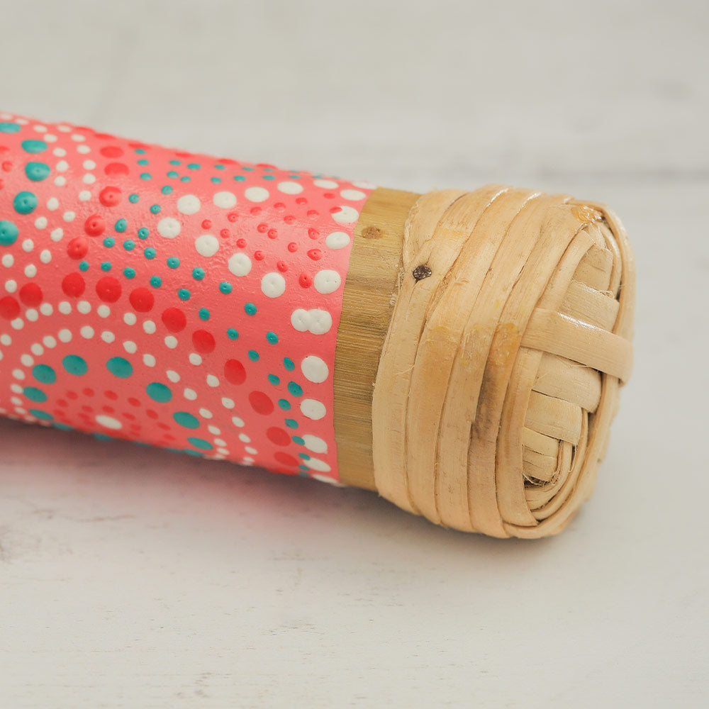 Close up of the pink 15cm bamboo rainstick end with dot painted design