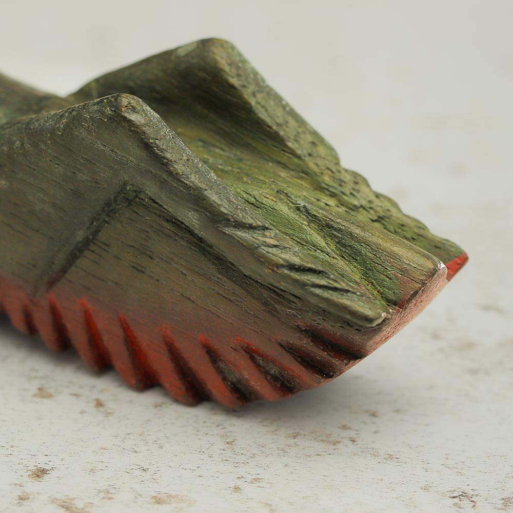 Back of the cricket guiro Close up showing red and green colour ridges