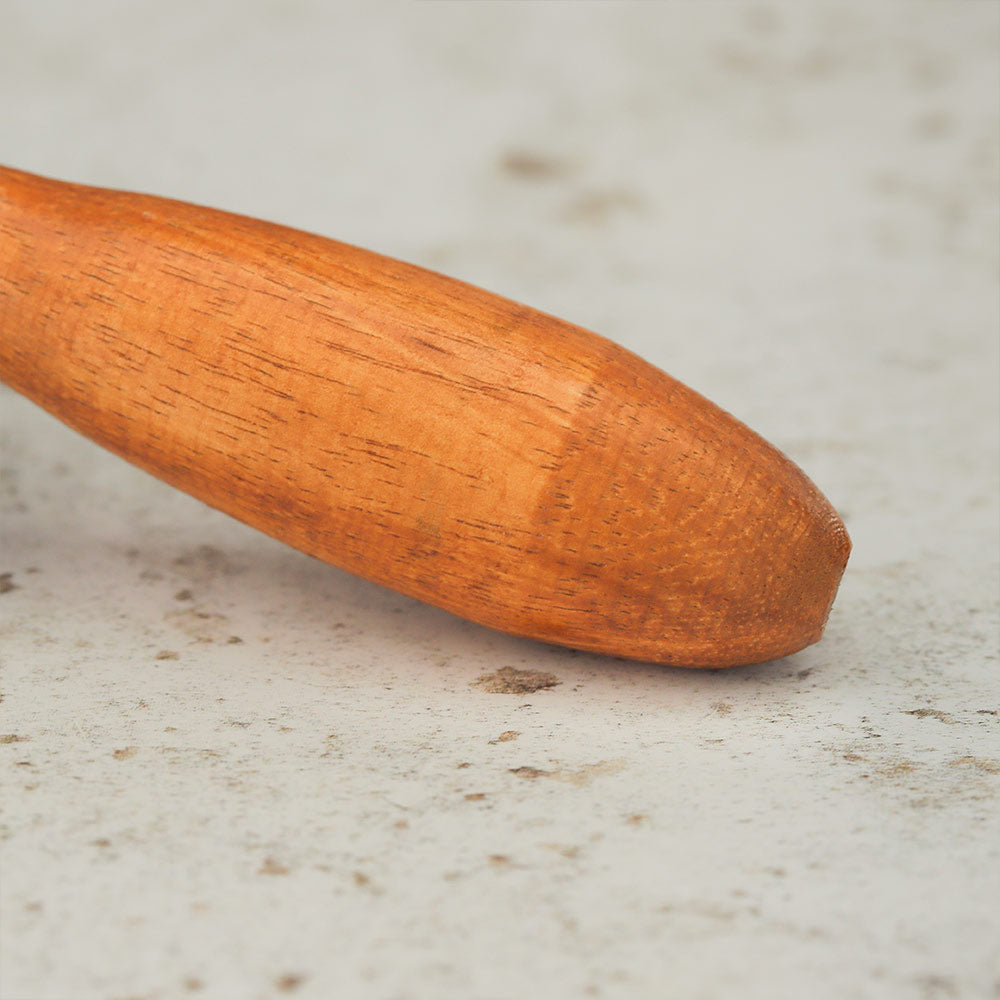 Close up of the coconut shell maraca wooden handle