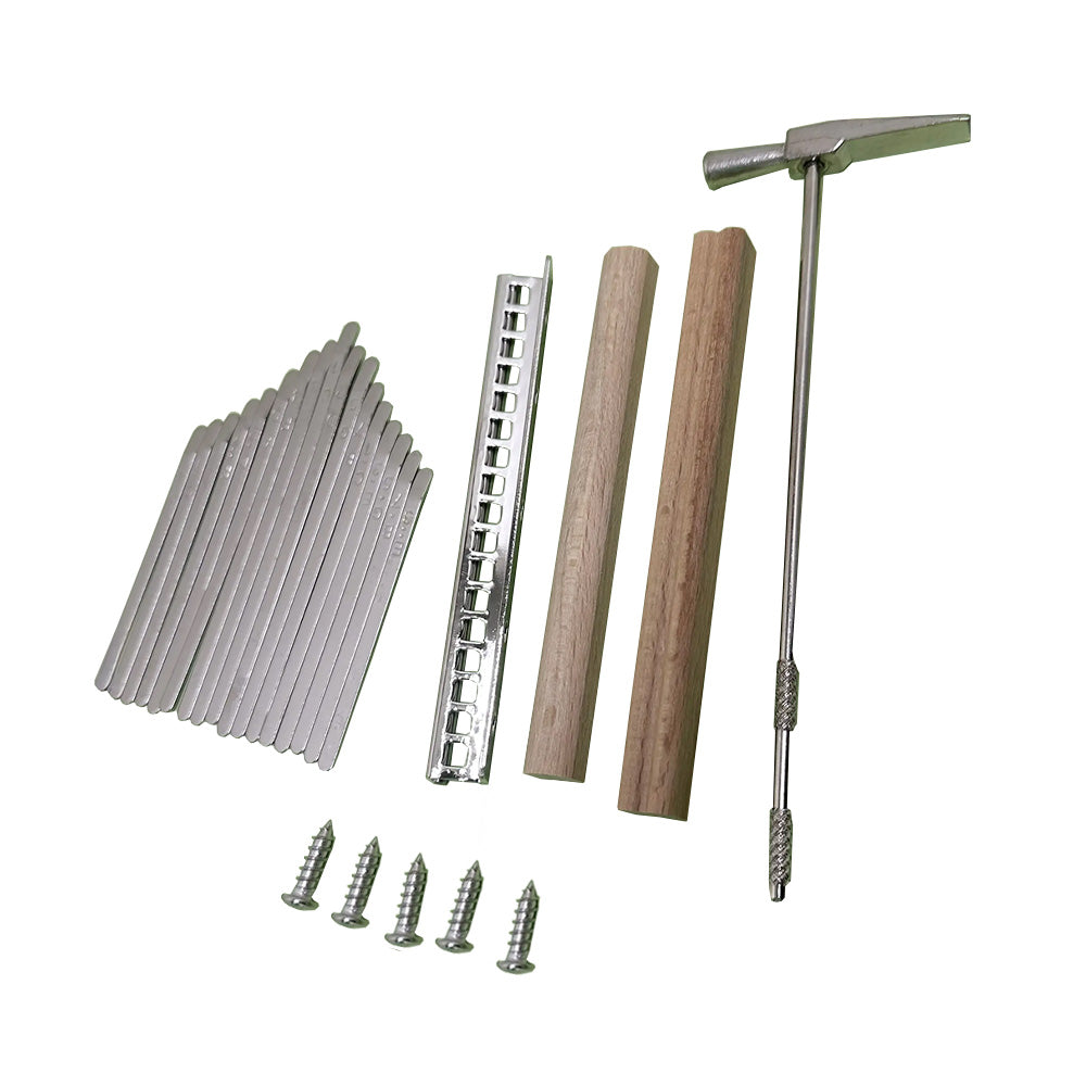 DIY Kalimba kit including notes, metal bar, wooden body, screws, and tuning hammer, laid out for assembly.