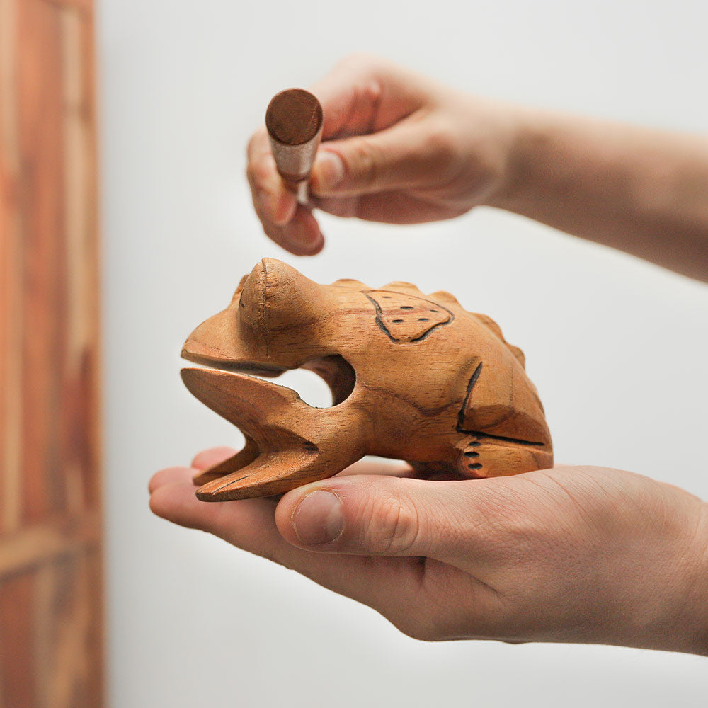 Indonesian Jati frog guiro from Bali held in hand to show scale and size.