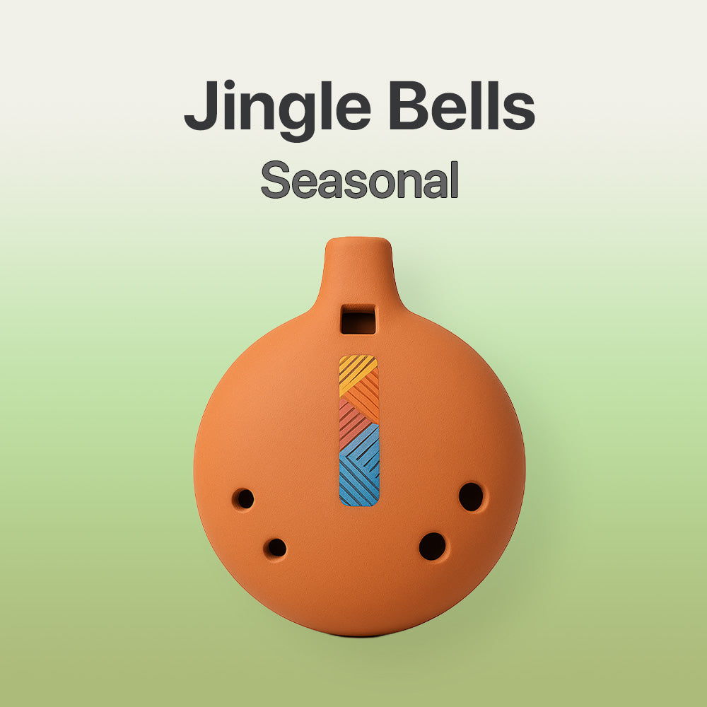 Terracotta-colored ocarina with colorful design on a light green background, labeled 'Jingle Bells Seasonal'.
