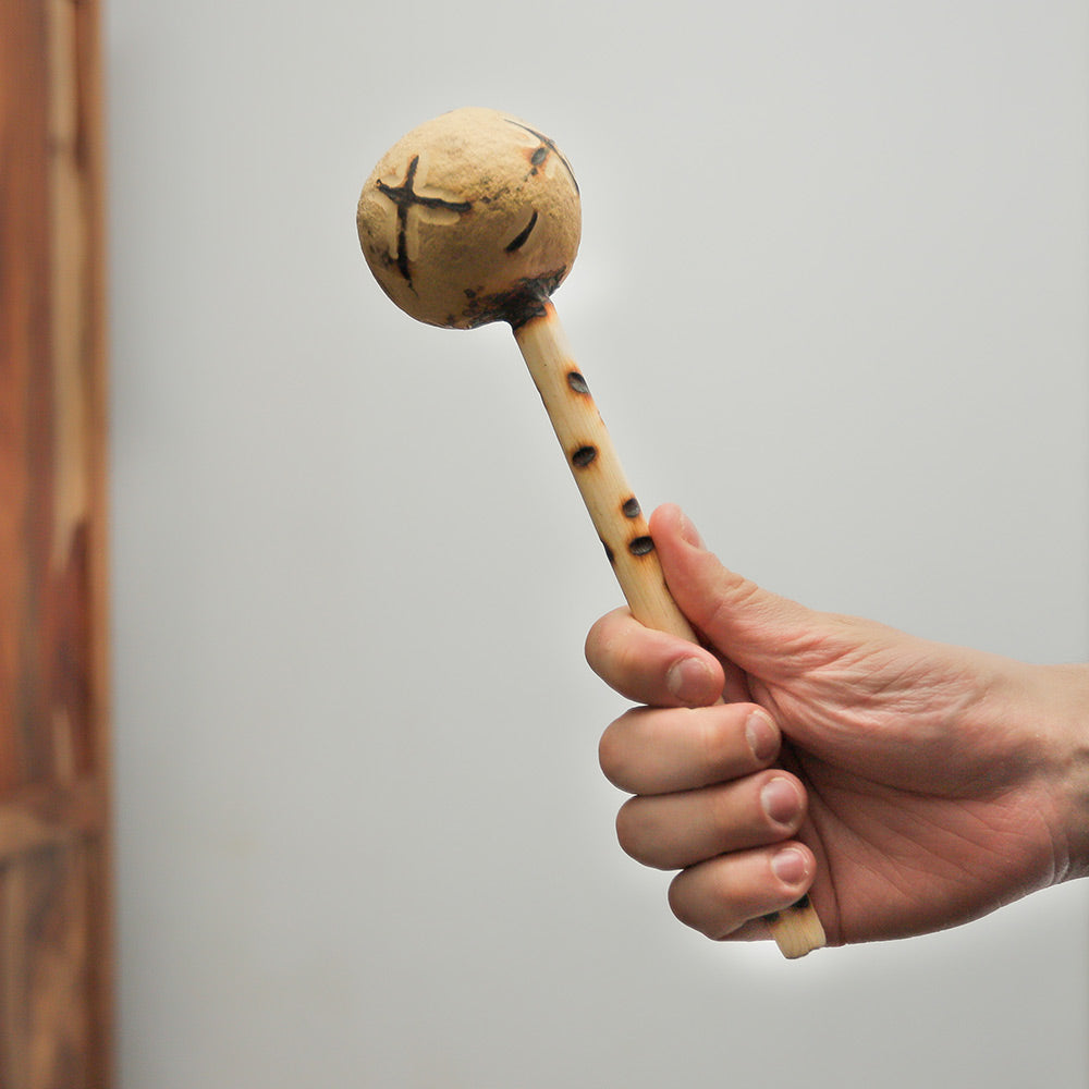Kenyan gourd shaker held in hand, showing its size and natural texture.