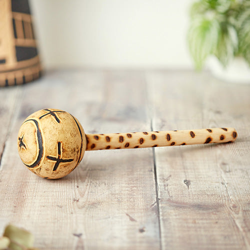 Gourd shaker instrument with tribal carvings and wooden handle