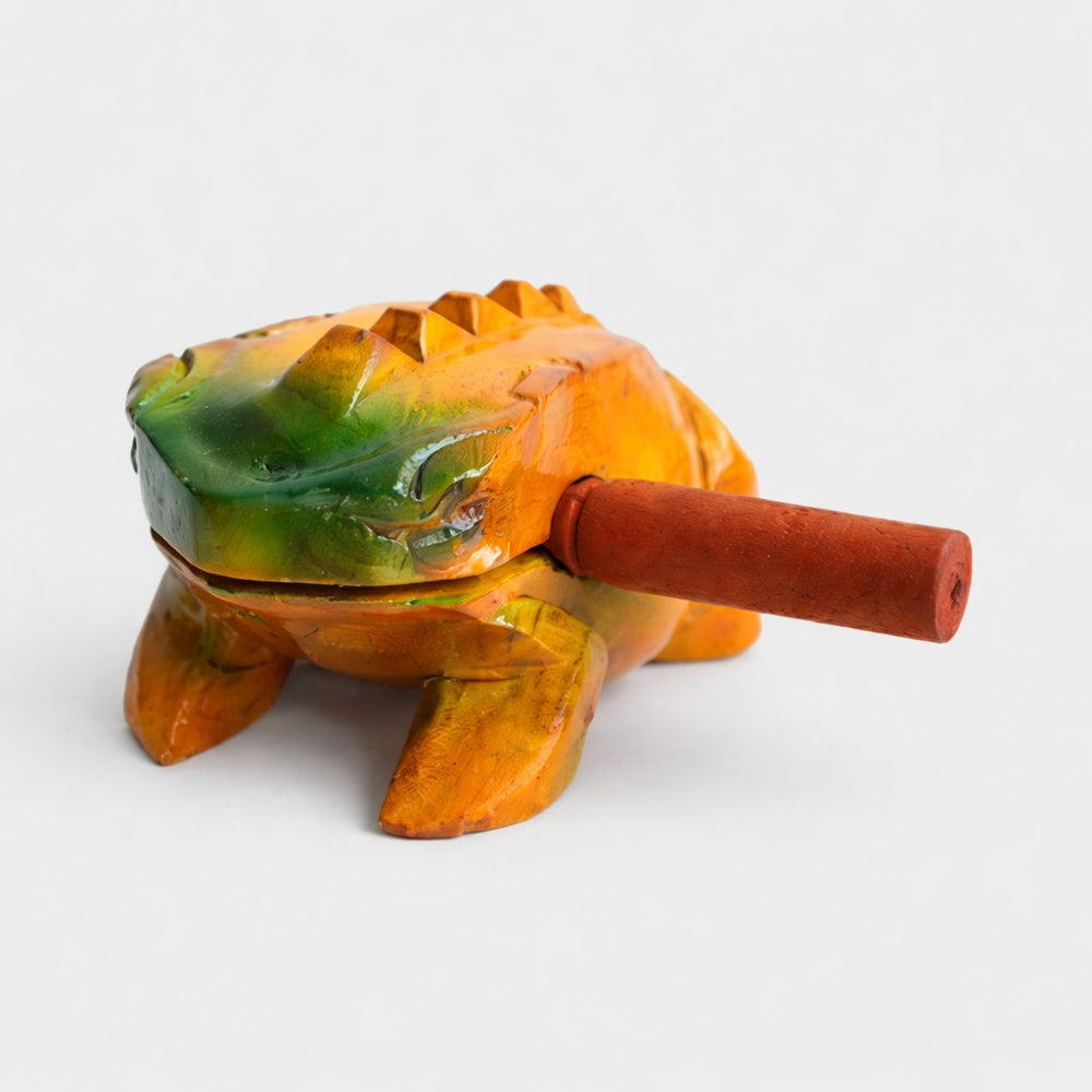 Large Vietnamese frog Guiro with a wooden beater on a white studio background