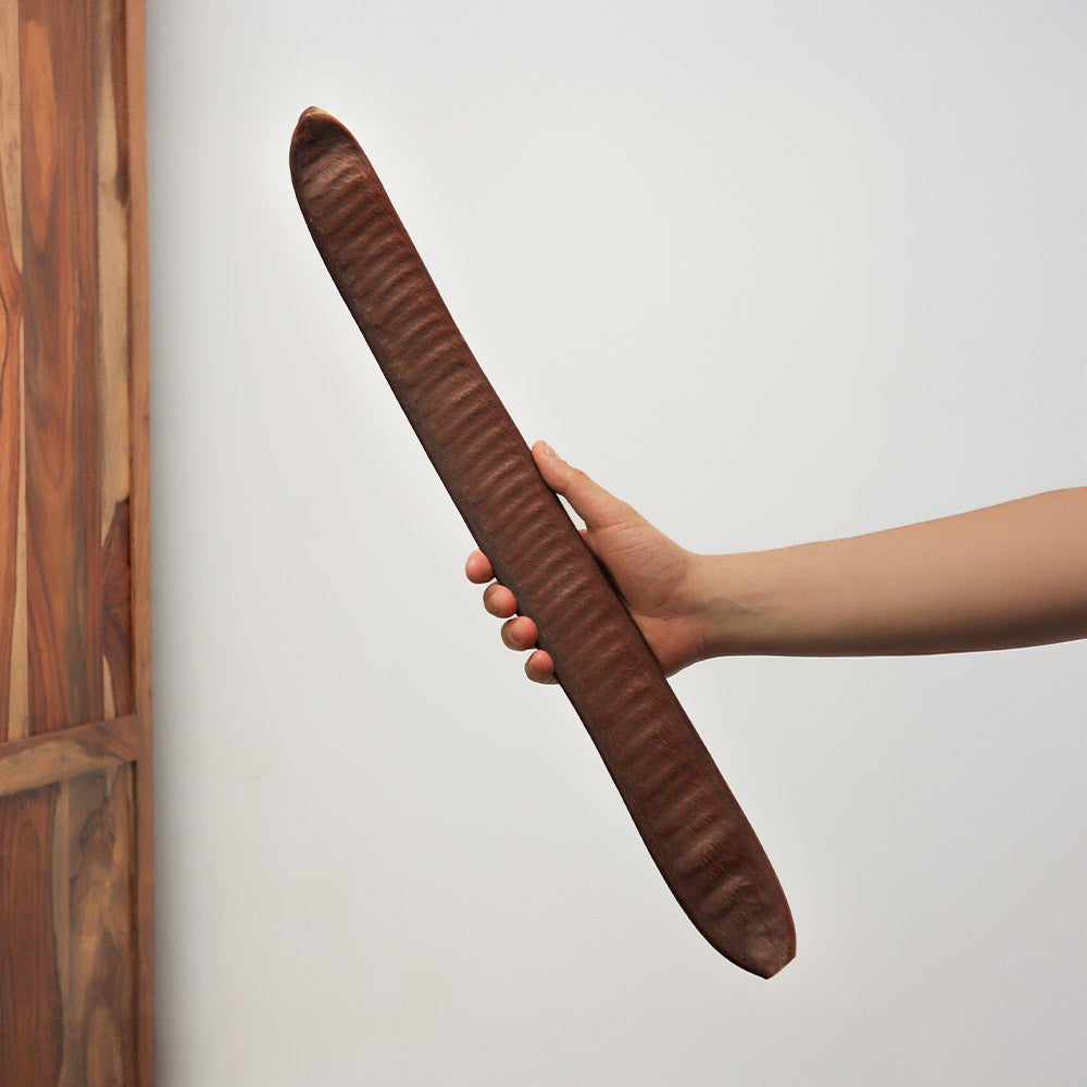 Handheld natural Pacay seed pod shaker, dark brown and unpainted, from Peru, South America.