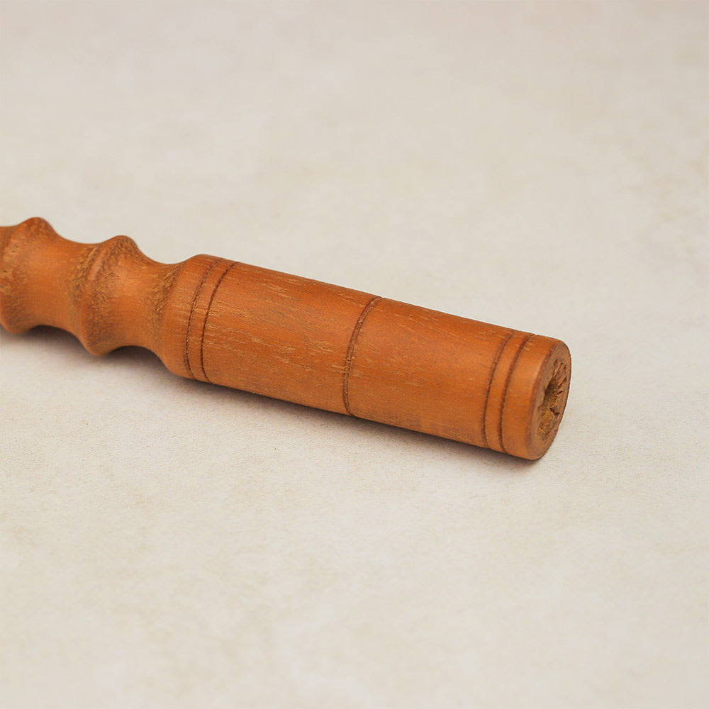 Close-up of the wooden handle of the Pasar Guiro, highlighting its smooth finish and ergonomic design.