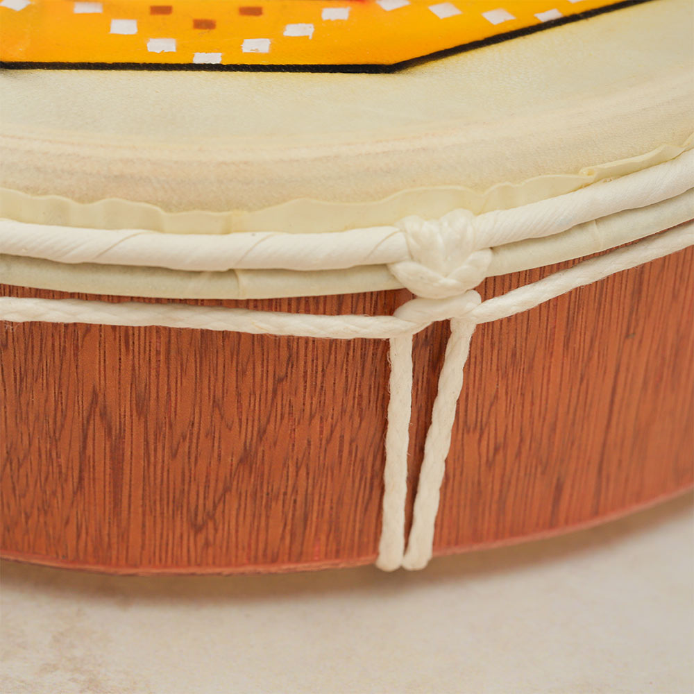 Close-up of the side of the wooden frame of the Sacred Circle Shamanic Drum, showcasing the structure.