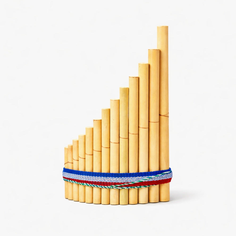 Bamboo pan flute with a colourful blue ribbon band on a white background.
