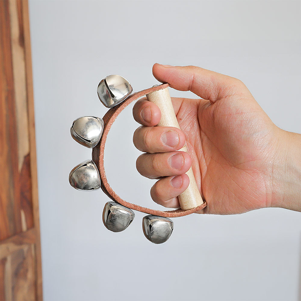 Sleigh Bell Shaker with five bells held in the hand to show scale size