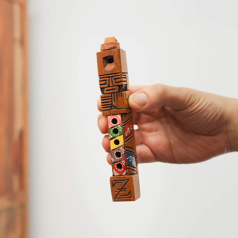 Handheld wooden Peruvian tarka flute, carved and painted, woodwind instrument.