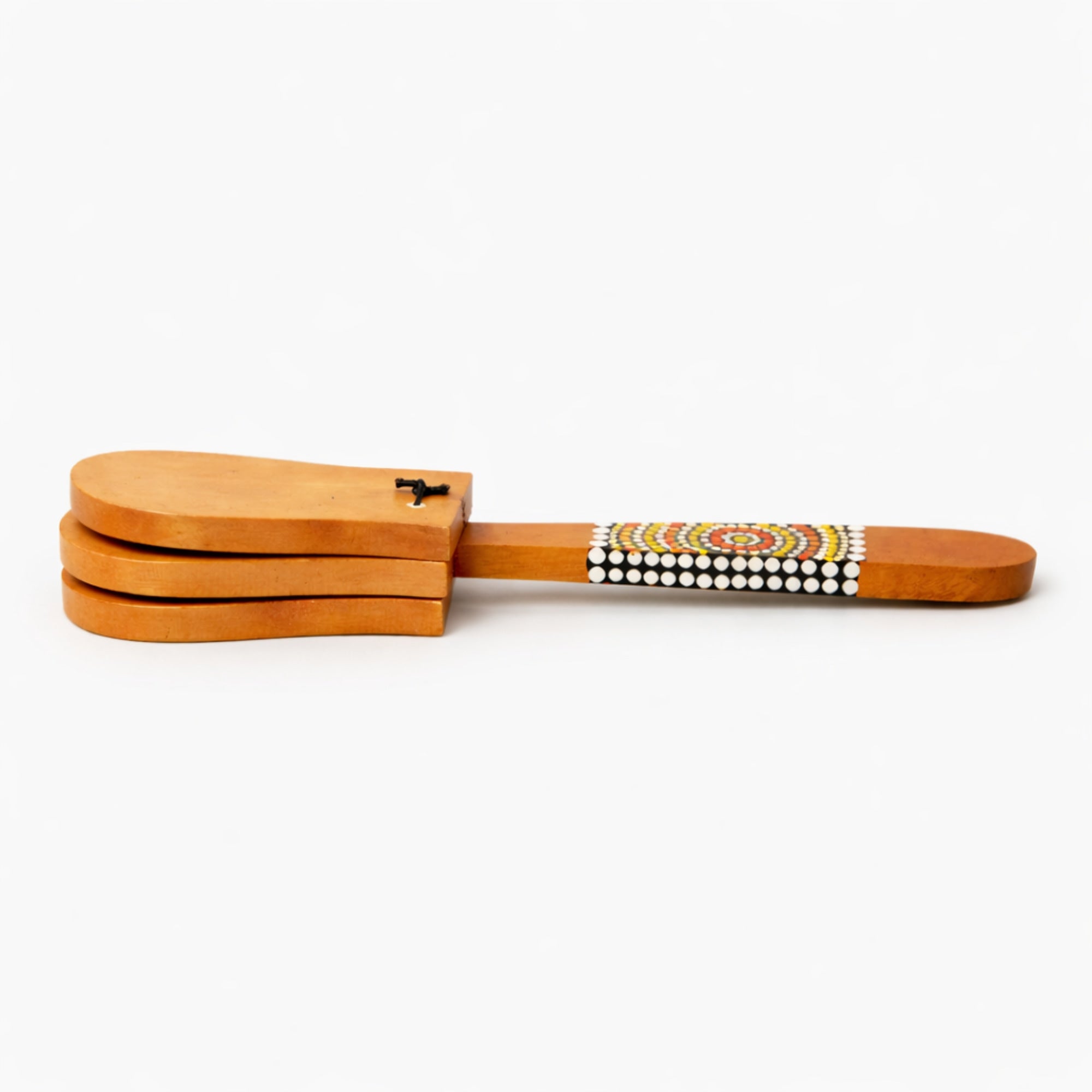 Painted solid wood castanets percussion instrument with dot painted design on a white background