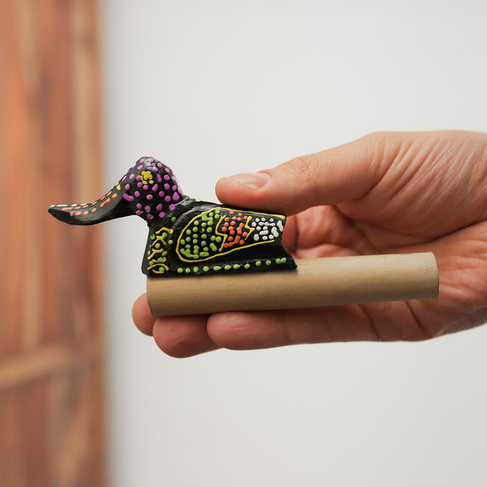 Handheld wood and bamboo duck quacker whistle with dot-painted design, made in Indonesia.