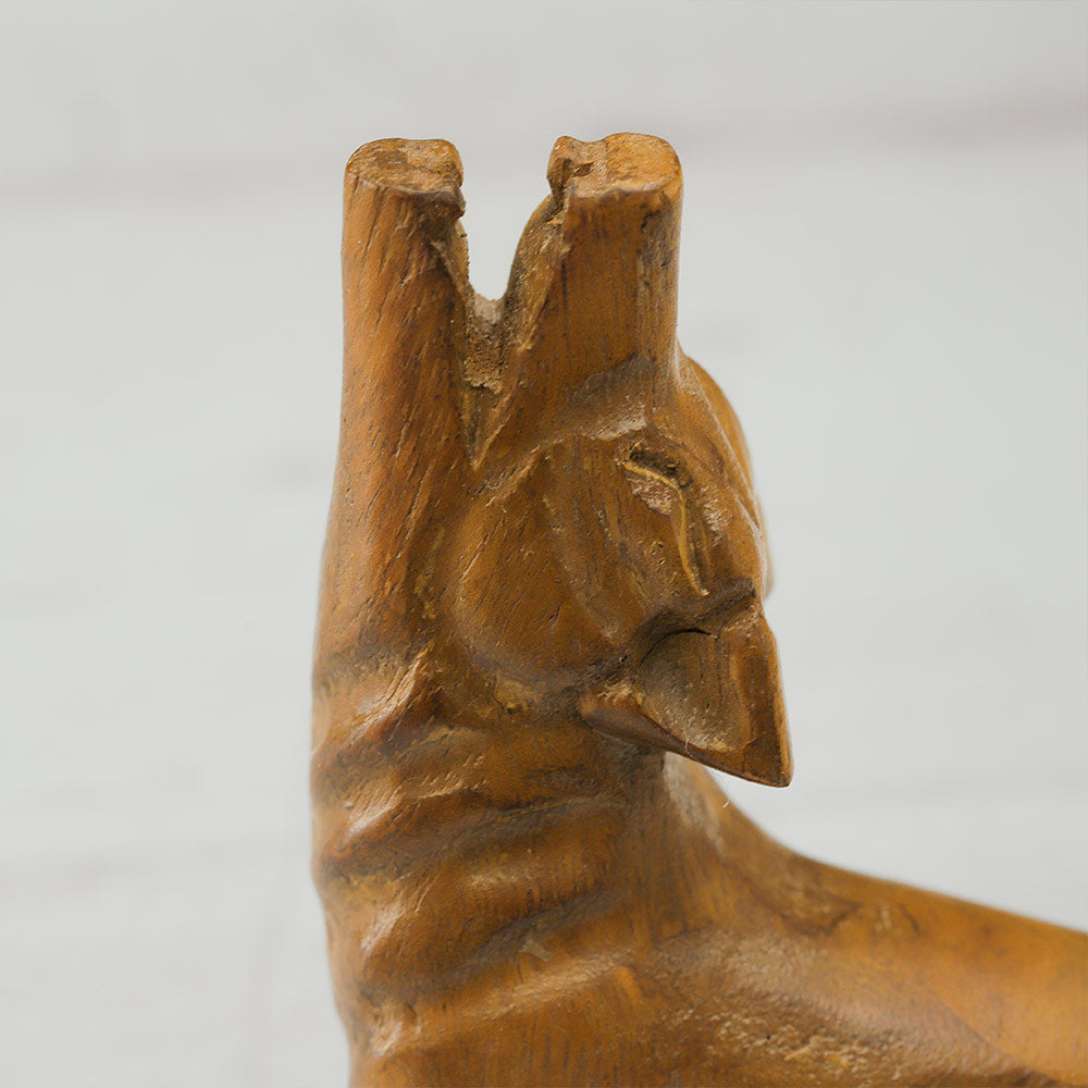 Close-up of the face of the wooden howling wolf whistle.