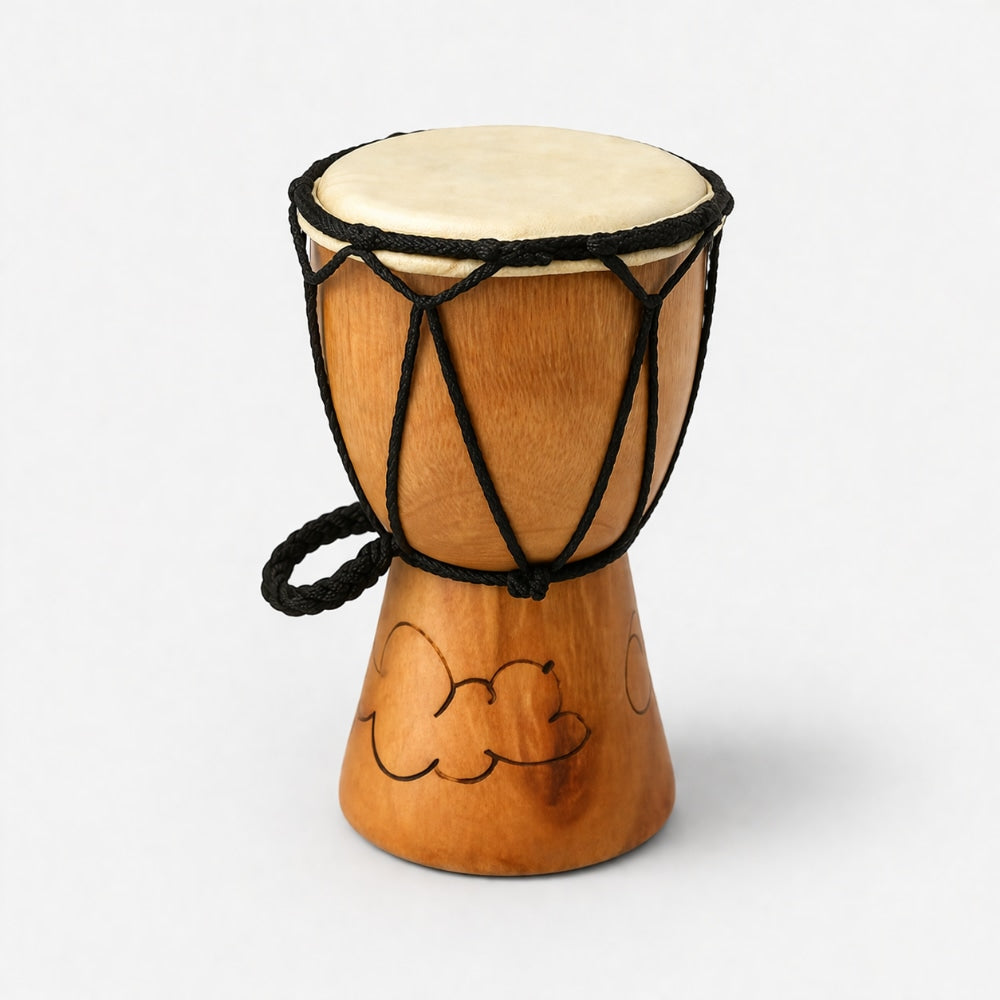 Wooden Indonesian djembe drum with a animal hide head and black rope tuning mechanism on a light gray background