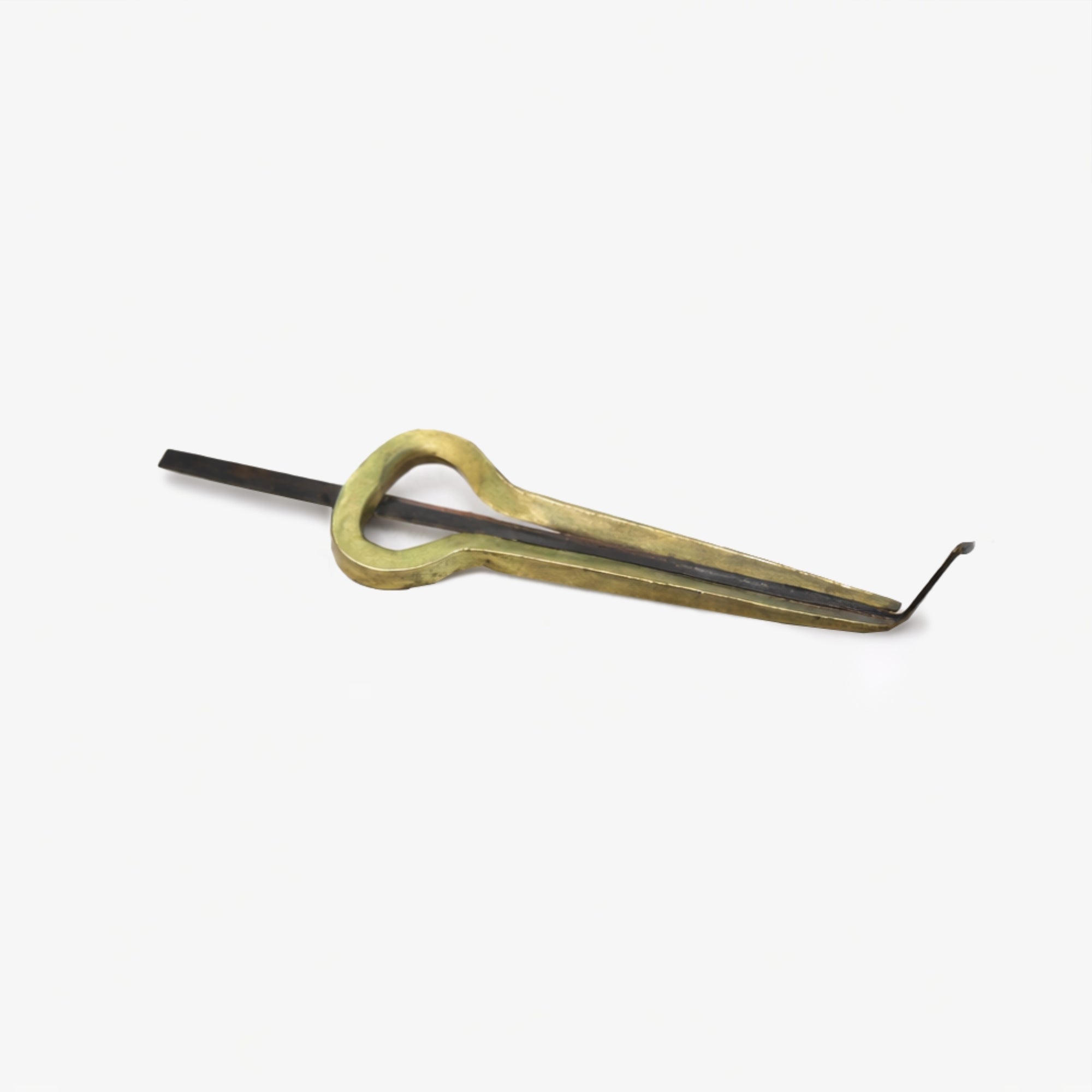 Small brass mouth jaw harp on a grey studio background