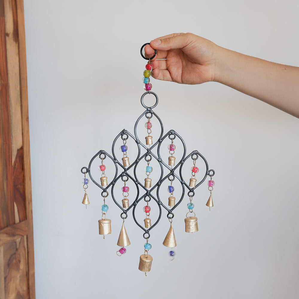 scale hand image of cast iron windchime