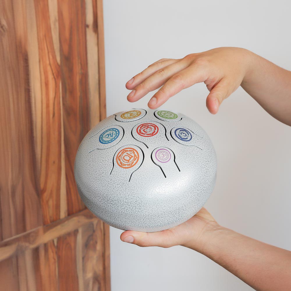 chakra white tongue drum in hand
