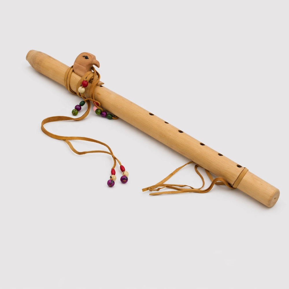 Bamboo flute with decorative beads on a white background