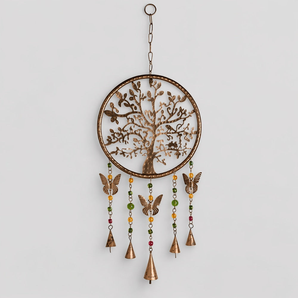Decorative hanging ornament with tree design and bells on a light gray background