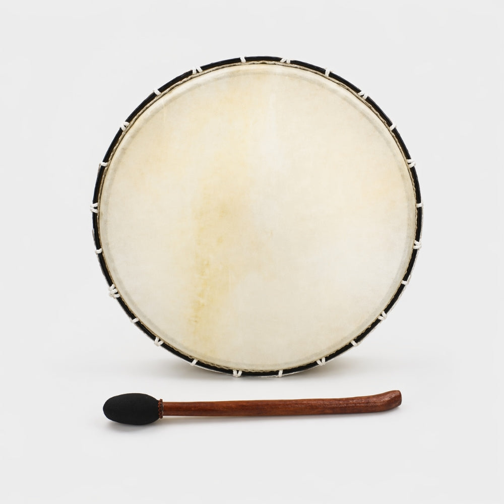 Goats hide plain shamanic Drum with beater mallet on a white studio background