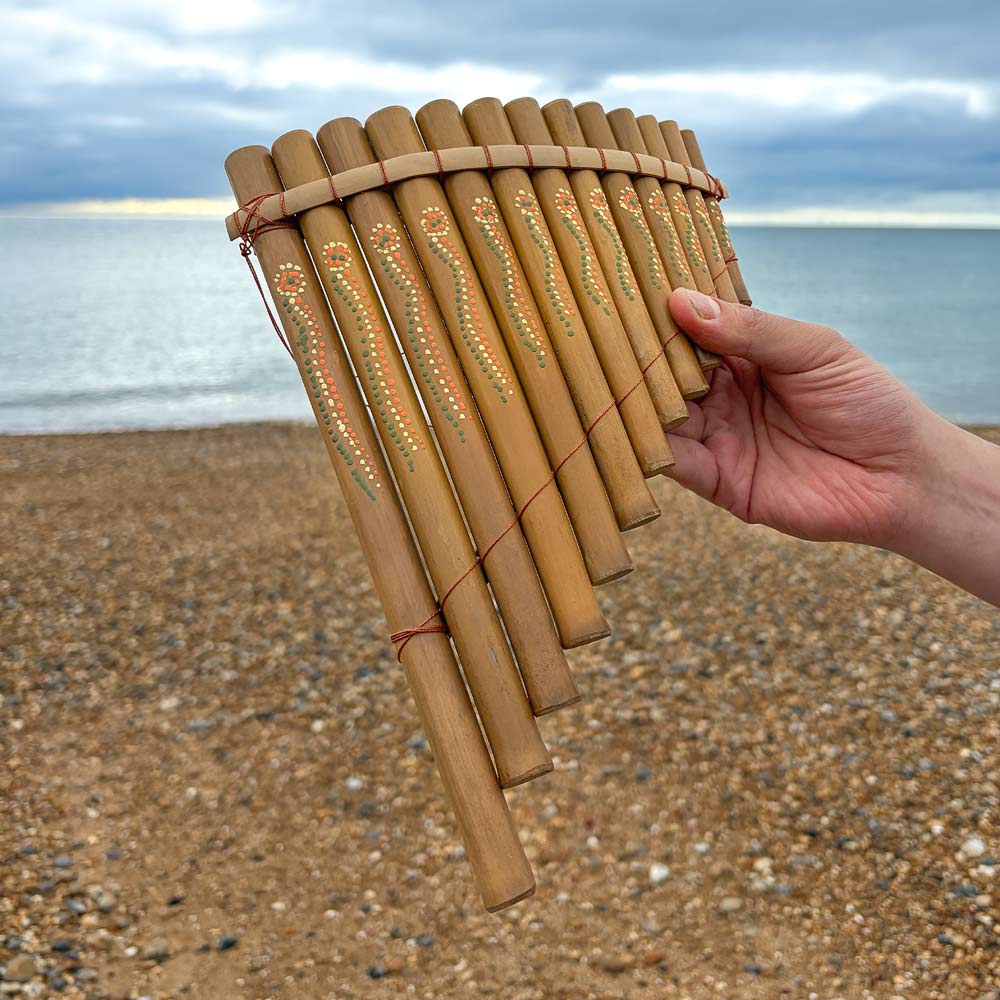 bamboo pan pipes held in hand at the beach