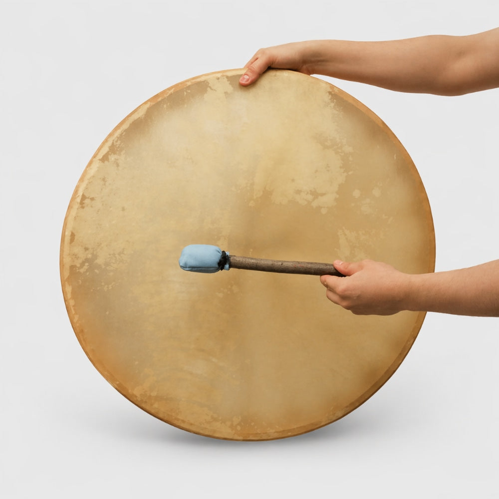 Large 24 inch khenji cow hide shamanic drum with a blue tipped mallet beater on a white studio background