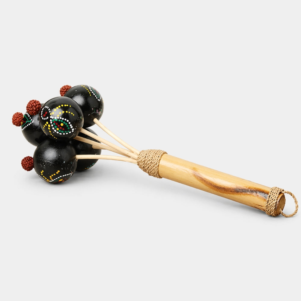 Decorative rattle with black beads and a wooden handle on a white background