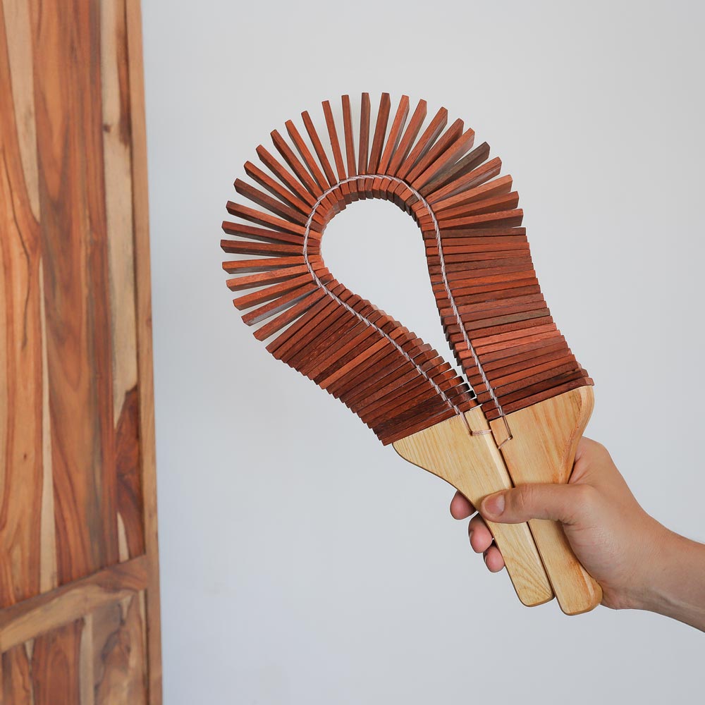 dark brown kokoriko shaker in hand