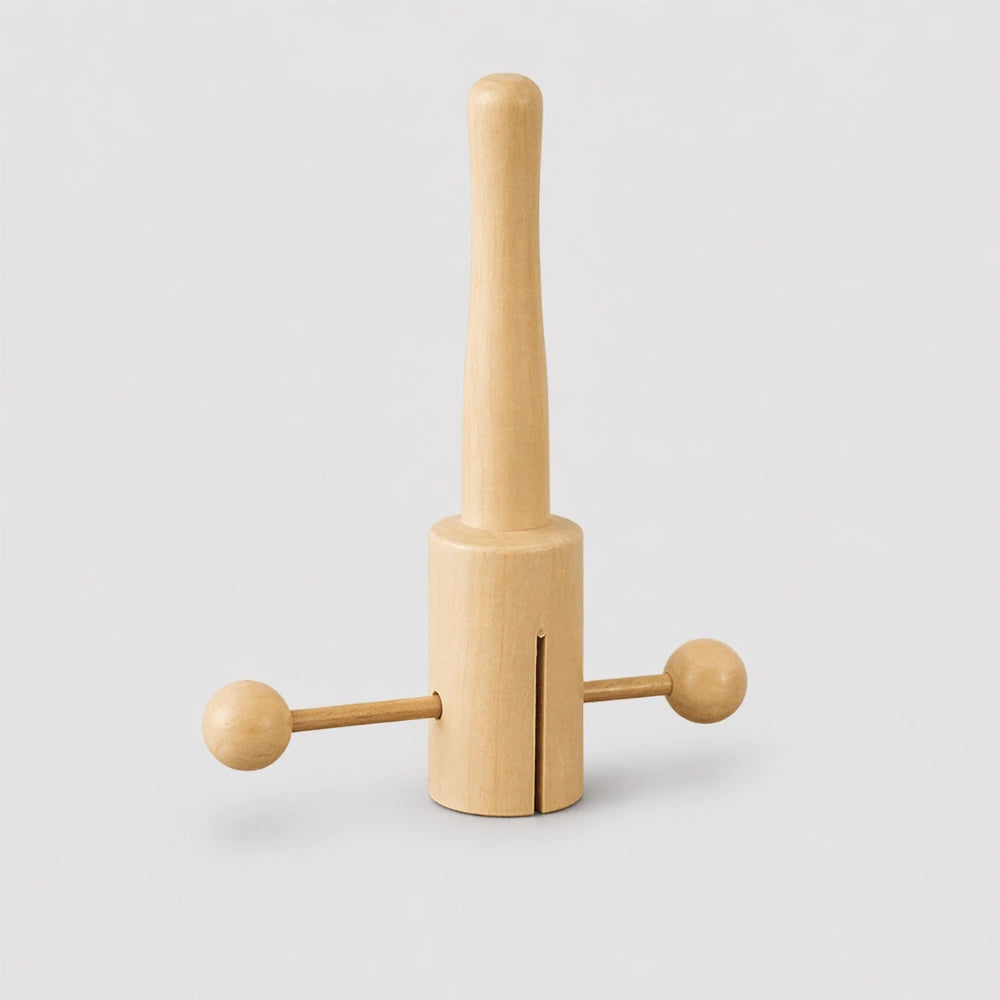 Matsu T-clacker musical instrument on wooden table