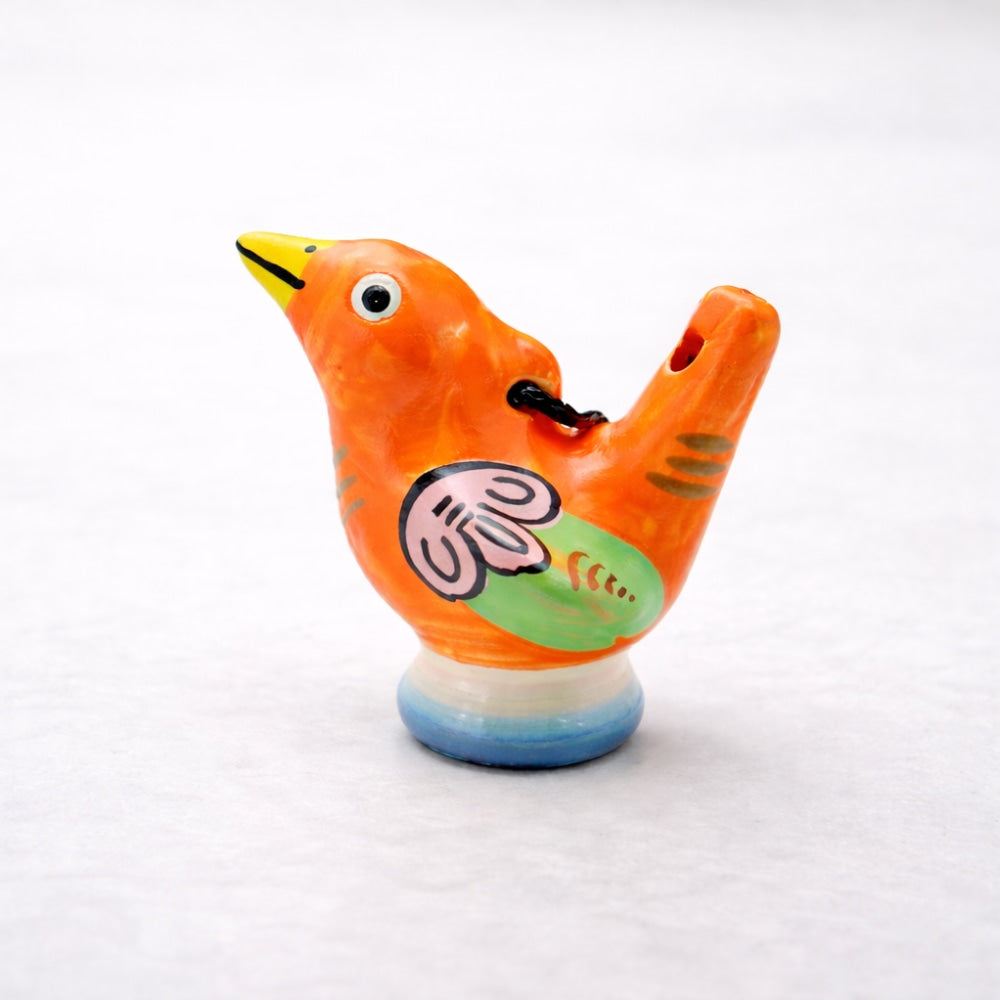 Colorful ceramic bird-shaped object on a white background