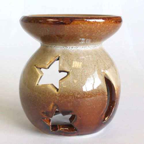 Ceramic oil burner with star designs on a white background