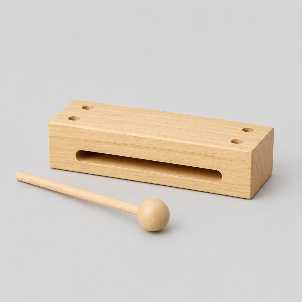 Wooden block with a mallet on a gray background