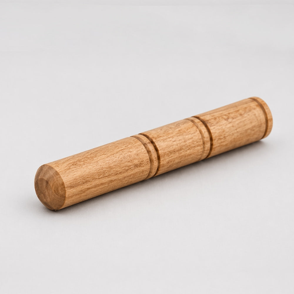 Solid wood replacement singing bowl beater on a light gray studio background