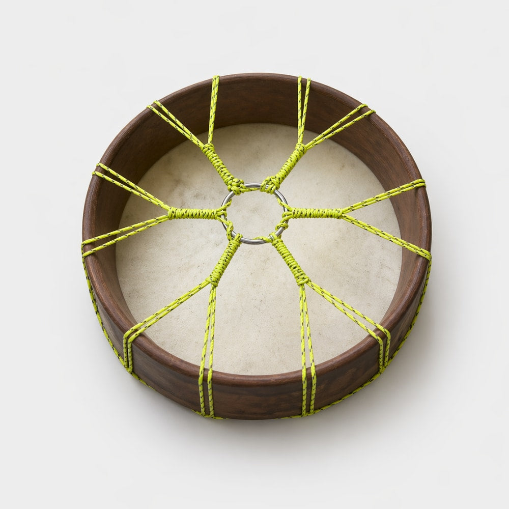 Traditional Pakistani shamanic drum with hand-tied yellow rope on a white background