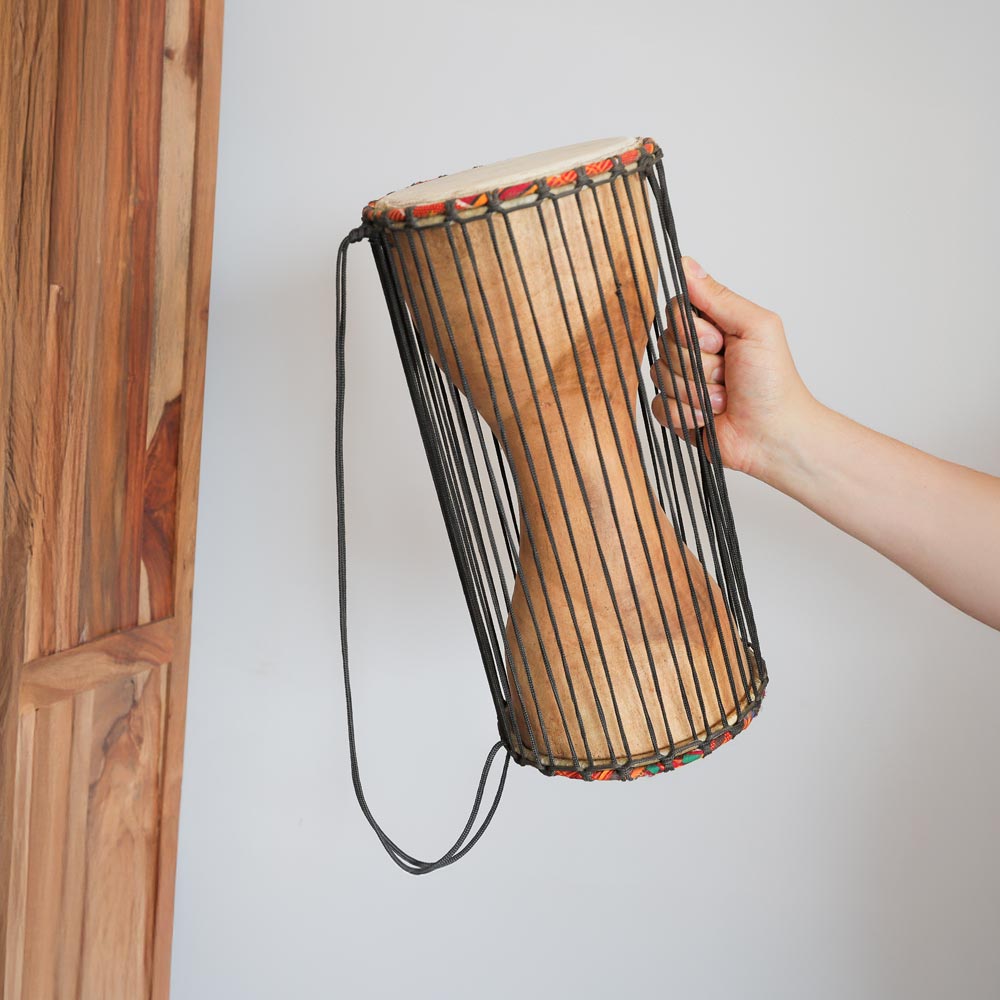 medium talking drum in hand