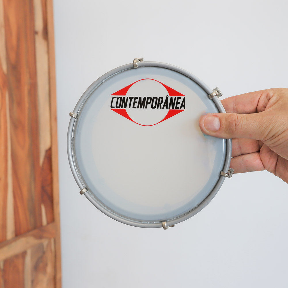 scale image in hand of contemporena samba tamborim in hand