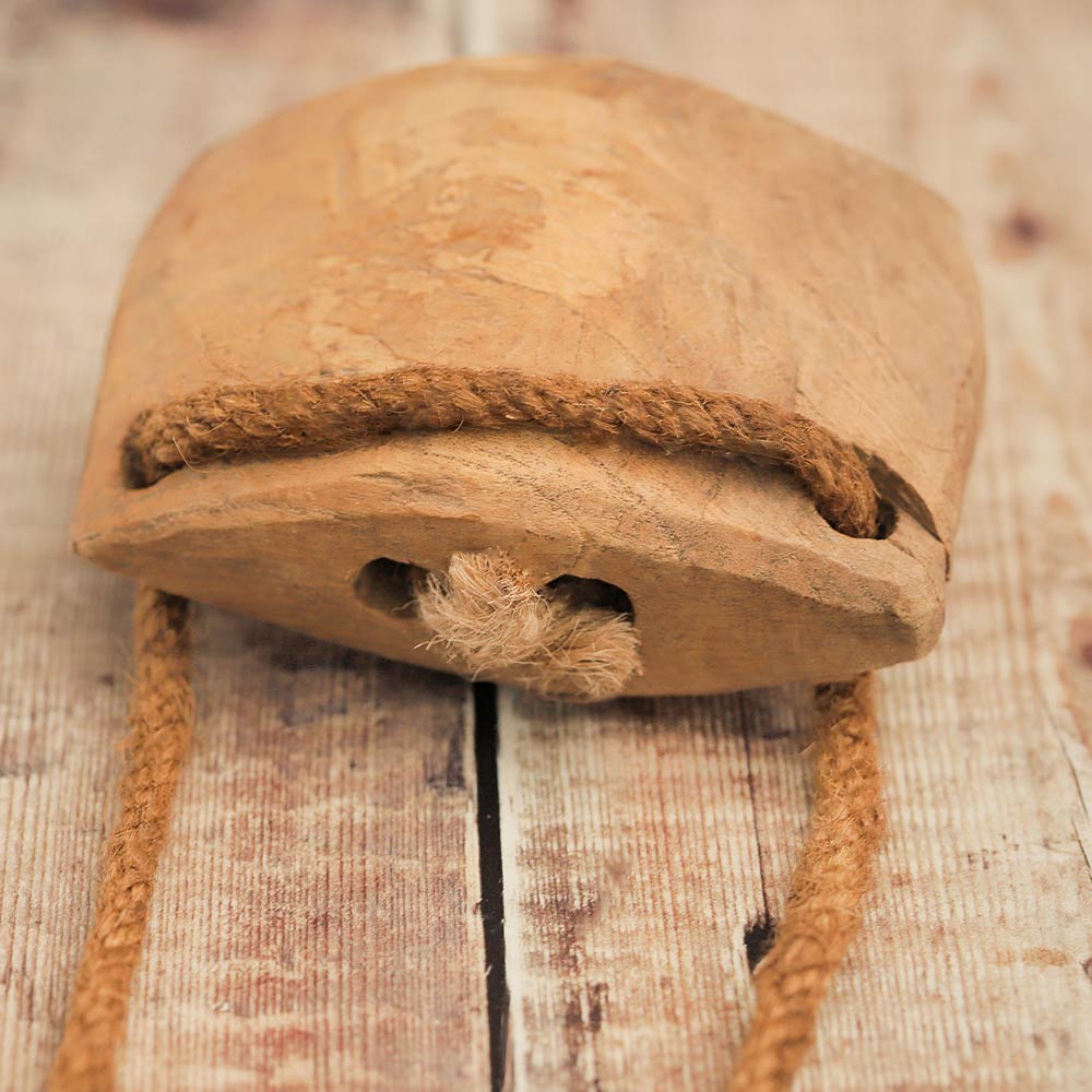 close up of top of wooden cow bell